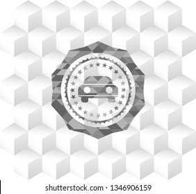 car seen from front icon inside grey badge with geometric cube white background