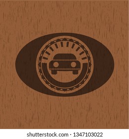 car seen from front icon inside badge with wood background