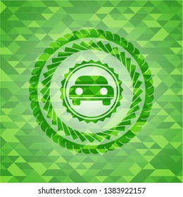 car seen from front icon inside realistic green emblem. Mosaic background
