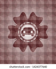 car seen from front icon inside red seamless emblem with geometric pattern background.