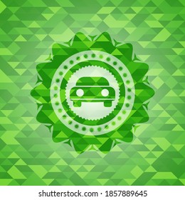 car seen from front icon inside green mosaic emblem. 