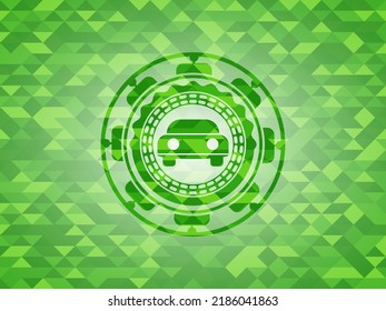 car seen from front icon inside realistic green mosaic emblem. 