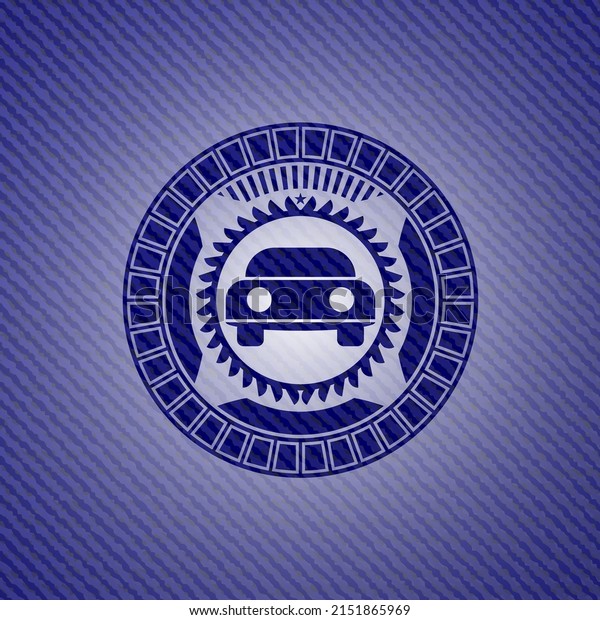 car seen from front icon inside emblem with jean\
background. 