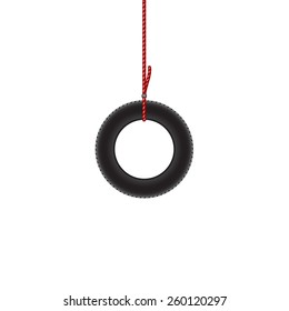 Car tire hanging on red rope