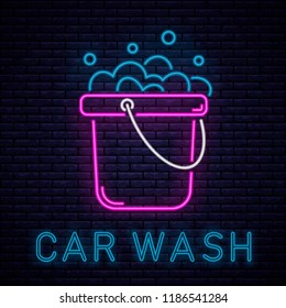  Car wash neon word and automobile in foam logo. Vector illustration in neon style. Auto cleaning service glowing sign.