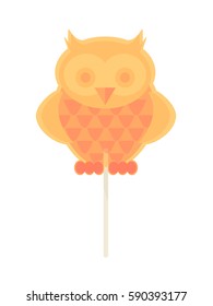 Caramel candy on a stick in the form of an owl. For children on holidays

