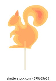 Caramel candy on a stick in the form of squirrel. Festive dessert for the holidays for children.