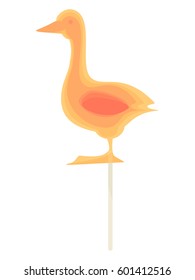 Caramel candy on a stick in the form of goose. Delicious sweet snack for kids.