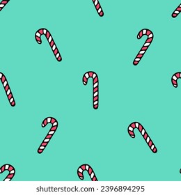 Caramel candy in the shape of a cane. Repeating vector pattern. Isolated green background. Sweet lollipop. Seamless ornament. Sweet background. Cartoon style. Festive print. Idea for web design