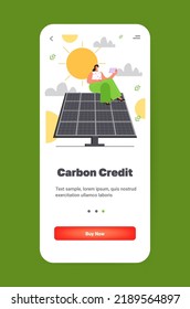 carbon credit concept woman using laptop on solar panel responsibility of co2 emission environmental conservation