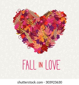 Card with big heart made of autumn leaves and text Fall In Love