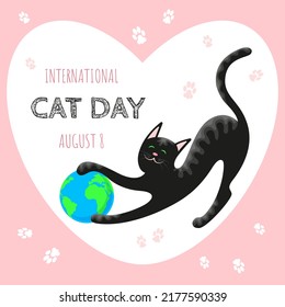 Card with a black cat playing with a globe-ball for International Cat Day on a pink background in a frame in the shape of a heart