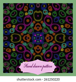 Card with circular pattern of doodles, spots, label. Hand drawn.
