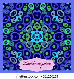 Card with circular pattern of doodles, spots, label. Hand drawn.