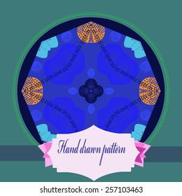 Card with colored circular floral motif, label on a dark blue   circle. Handmade.