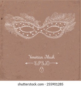 Card with festive venetian mask on brown parcel paper
