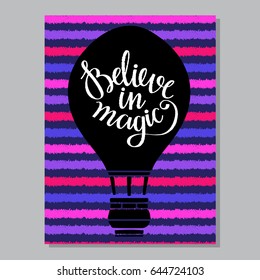 Card with hot air balloon. Striped background. Believe in magic hand written font