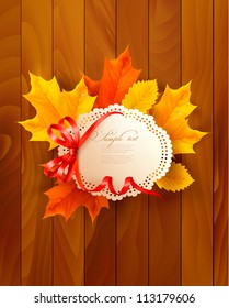 Card with leaves with a bow on wooden background. Vector.