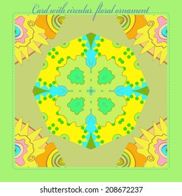 Card with pattern from colored   floral  circular ornament in light yellow and green tones in yellow pale rounded rectangle and blue pale text.