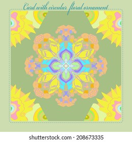 Card with  pattern from colored  floral circular ornament in light  tones on green pale rounded rectangle and text.