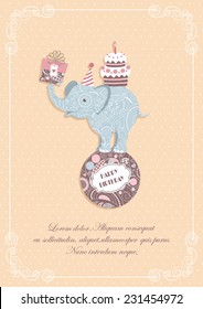 Card with patterned elephant with cake and present on the ball on beige with calligraphic frame. Vector background.