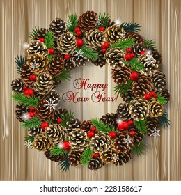 Card for the winter holidays with a realistic wreath of fir cones, fir branches and red beads on wood background. Place for text. Christmas and New Year design.
