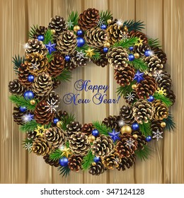 Card for the winter holidays with a realistic wreath of fir cones, fir branches and beads on wood background. Place for text. Christmas and New Year design.