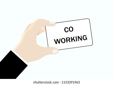 A card with the words "co working" in the hands of a businessman.