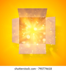 Cardboard box with a bright glow inside. Open box. Top view. Detailed bokeh effect.