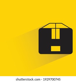 cardboard box with shadow on yellow background