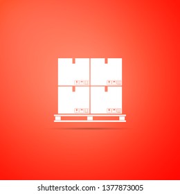 Cardboard boxes on pallet icon isolated on orange background. Closed carton delivery packaging box with fragile signs. Flat design. Vector Illustration
