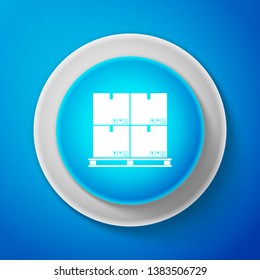 Cardboard boxes on pallet icon isolated on blue background. Closed carton delivery packaging box with fragile signs. Circle blue button. Vector Illustration