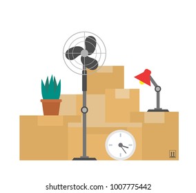 cardboard boxes with things plant lamp clock fan.moving day concept