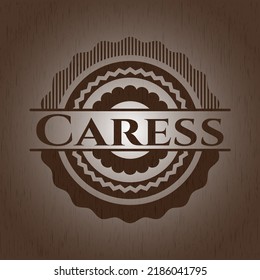 Caress badge with wooden background. 