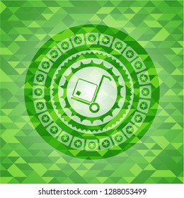 cargo icon inside green emblem. Mosaic background