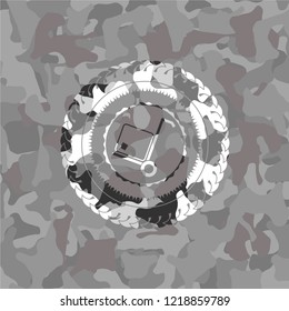 cargo icon inside grey camouflaged emblem