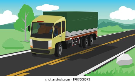 Cargo trucks with tarpaulins transportation journey. Only one man driving on the asphalt road with nature of meadow and mountains.