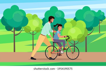 Caring dad teaching daughter to ride bike for first time. Father helping girl riding bicycle in park