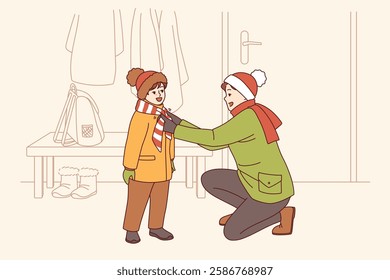 Caring father helps kid put on winter clothes so as not to freeze while walking along cold street. Happy father tying scarf to child showing care and desire to help smiling pre-teen son