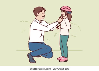 Caring father puts bicycle helmet on head of cyclists daughter to protect child from injury when falling from bicycle. Using child protection for cycling and avoiding accident or bruise