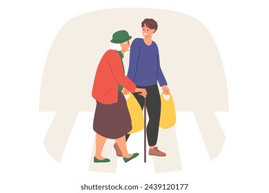Caring man helps elderly woman carry heavy bags home and talks with grandmother with smile. Kind guy takes care of pensioners, helps to go to grocery store or popular supermarket with quality food