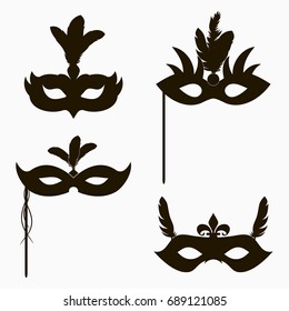 Carnival face masks icons. Set of isolated silhouette decoration for masquerade party with feathers and handle. Vector illustration.