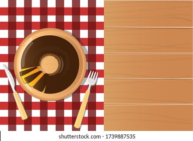 carrot cake with chocolate - festa junina food, on checkered tablecloth and wooden table top view