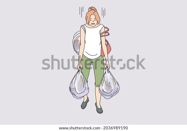 Carrying heavy bags\
tiredness concept. Young exhausted tired woman cartoon character\
going carrying many heavy shopping bags full of food from\
supermarket vector illustration\
