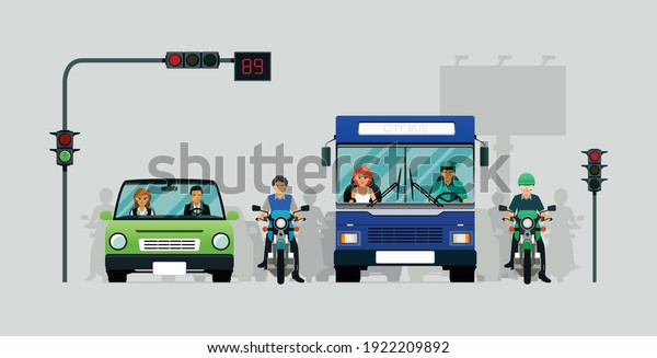 Cars and motorcycles are waiting for traffic\
lights with a gray\
background.