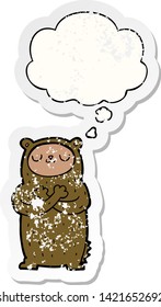cartoon bear with thought bubble as a distressed worn sticker