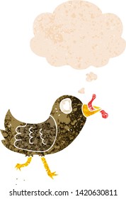 cartoon bird with worm with thought bubble in grunge distressed retro textured style