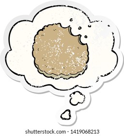 cartoon biscuit with thought bubble as a distressed worn sticker