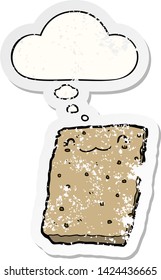 cartoon biscuit with thought bubble as a distressed worn sticker