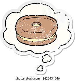 cartoon biscuit with thought bubble as a distressed worn sticker